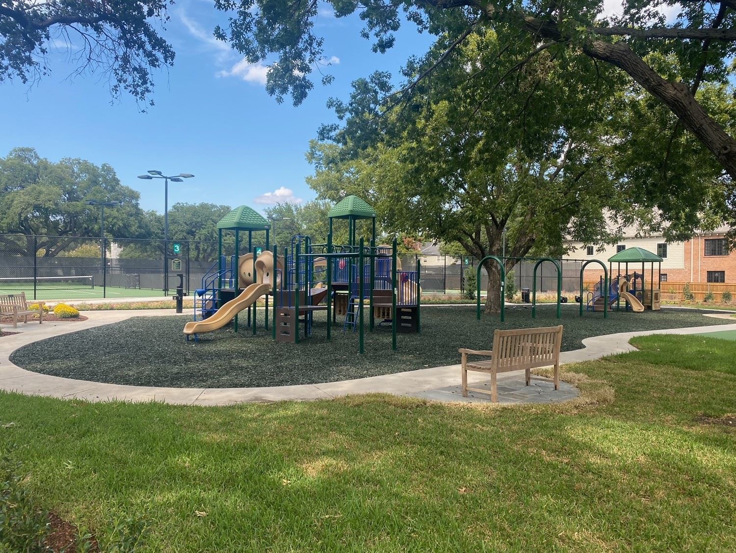photo of a play fort with walking trail around the perimeter and a bench
