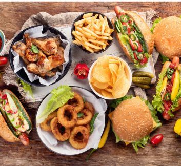 Photo of several American foods arranged on a wooden background. 