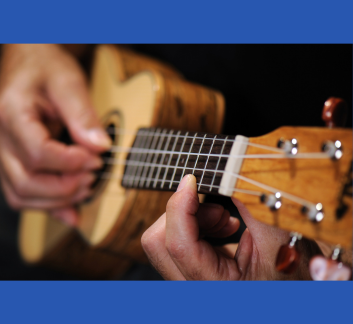 close up of someone playing a ukelele