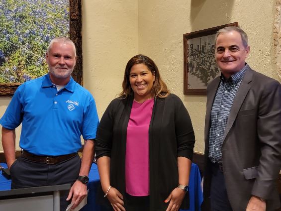 Three people grouped together, smiling at the camera